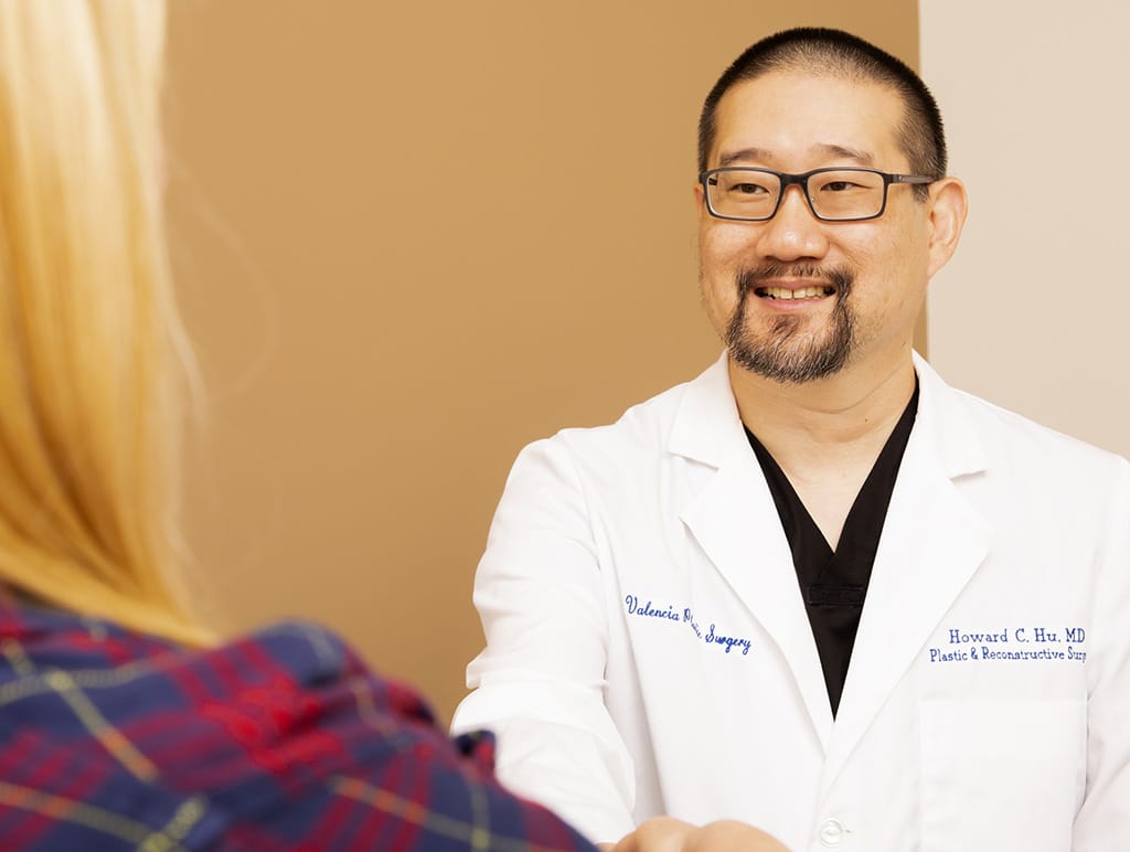 Dr. Hu shaking a potential client's hand